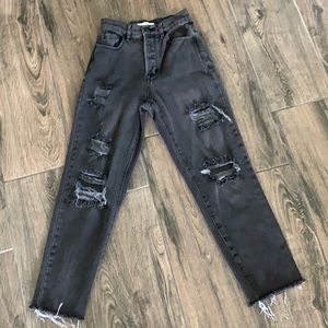 Faded black distressed high rise straight jeans.
